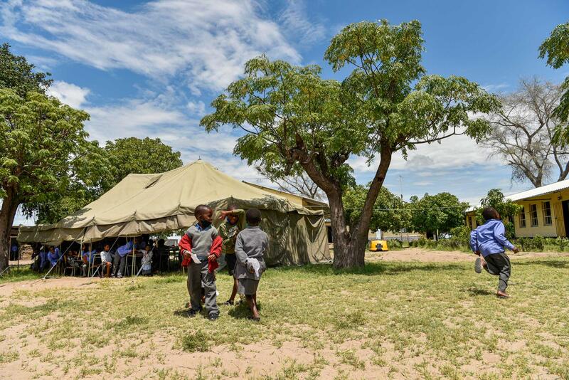 Lorsque nous arrivons à la Nsundwa Combined School, les enfants sont visiblement ravi·e·s. Les visiteur·euse·s de l'étranger sont en effet plutôt rares dans cet endroit reculé. Par manque de place, les enfants reçoivent parfois des cours sous des tentes.
